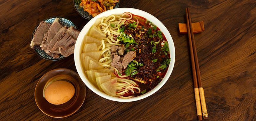 Lanzhou beef noodles: clear broth, white radish, red chilli oil, hand-pulled noodles and sliced beef