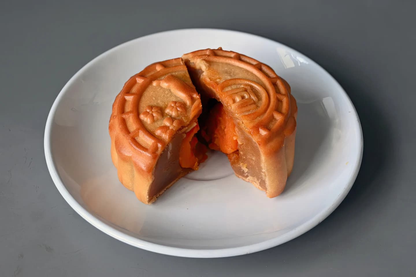 A lotus paste and salted egg yolk mooncake cut open