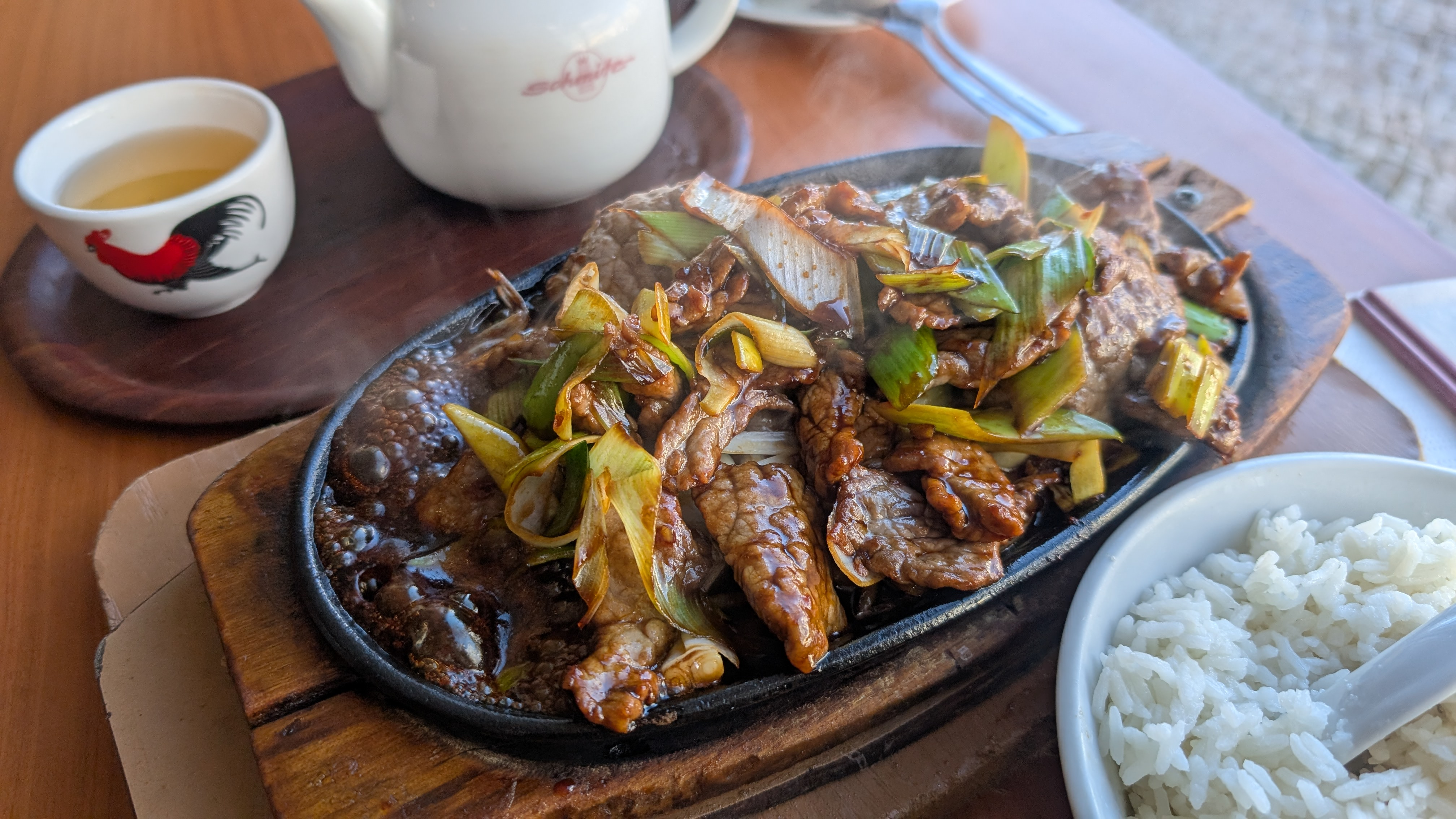 Fleisch auf einer heißen Platte mit Reis und Tee bei Tu Long